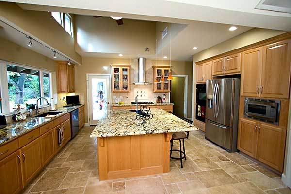 Finishing touches included etched glass cabinet doors, tumbled stone backsplash, and stainless appliances.